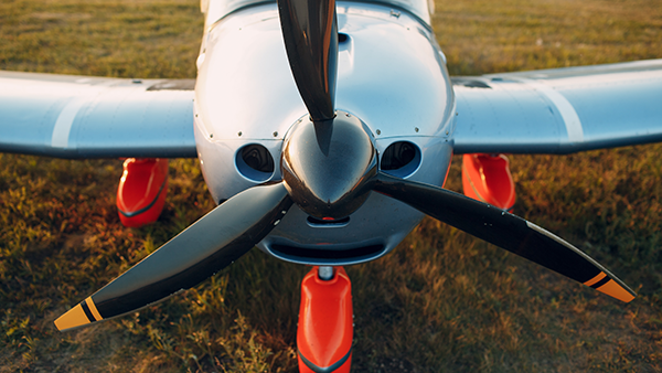 A small propeller plane parked on the ground.