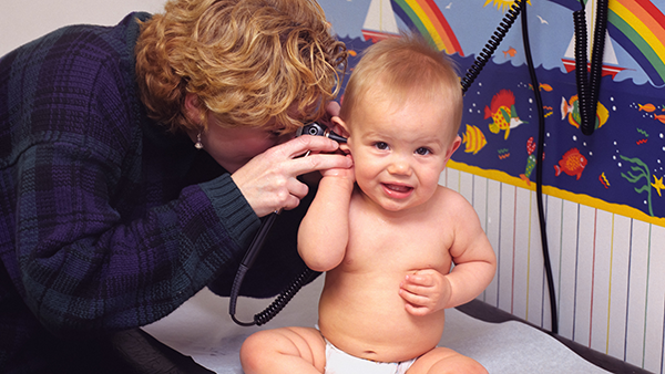 A doctor examining a toddler.