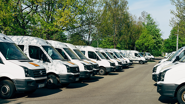 A fleet of vans in a parking lot.