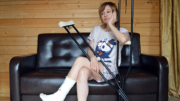 A young woman with crutches.