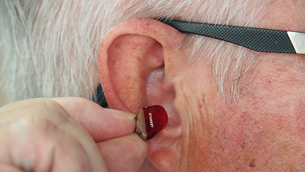 A person with a hearing aid.