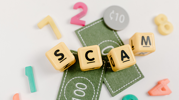 Children's blocks spelling out SCAM.