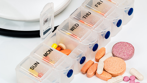 A pill organizer with pills in it.