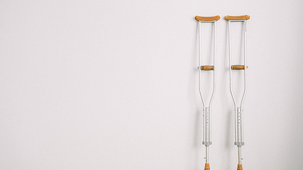 A pair of crutches leaning against a wall