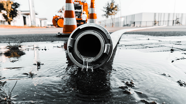 A hose on the ground with water flowing out of it