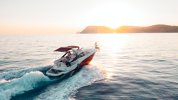 Speed boat on the water at sunset