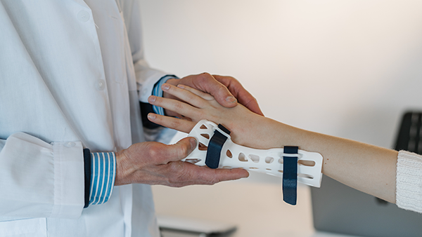 A medical provider examining a patient's hand