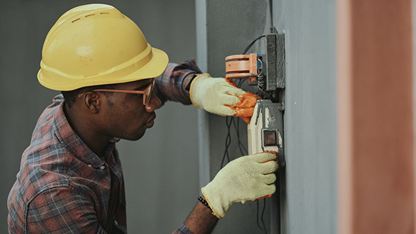 An electrician working on a panel.