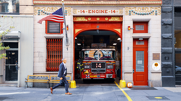 A fire truck parked in the garage bay of a fire station.