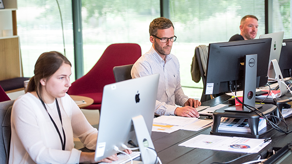 Multiple people working in an office.