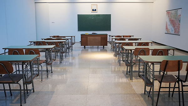 A classroom with a chalkboard and desks