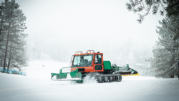 A snow plow clearing a road